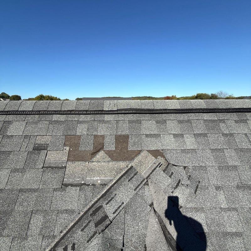 Roof shingles with visible hail damage and missing granules