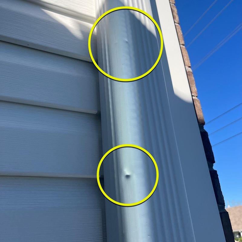 Aluminum downspout dent damage from hail impact