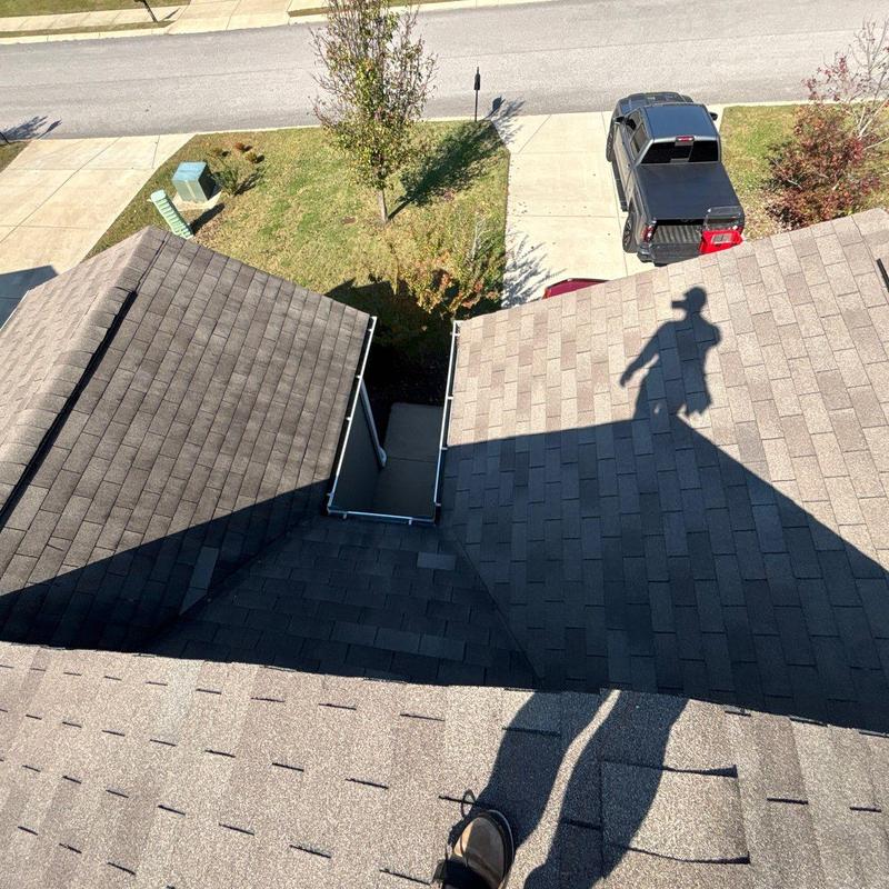 Asphalt shingle roof showing hail damage and inspection shadow