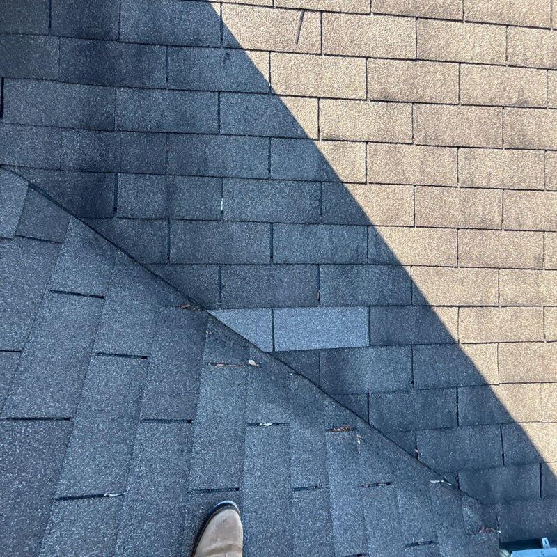 Asphalt roof shingles showing hail damage and repairs