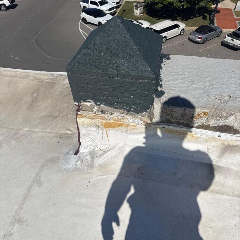 Roof flashing with patch and hail damage on commercial roof