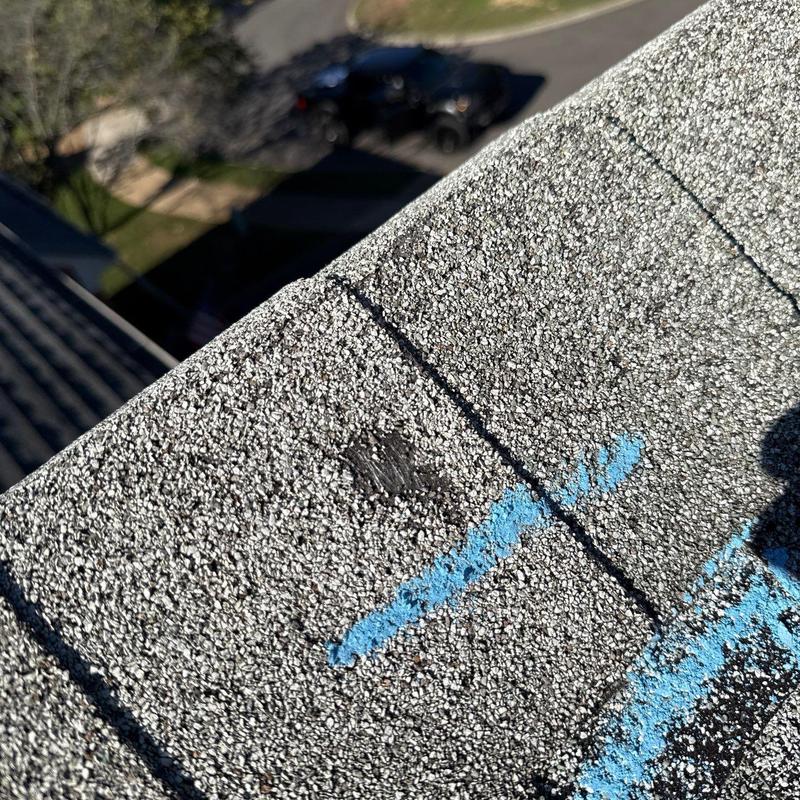 Asphalt shingle with hail damage and markings