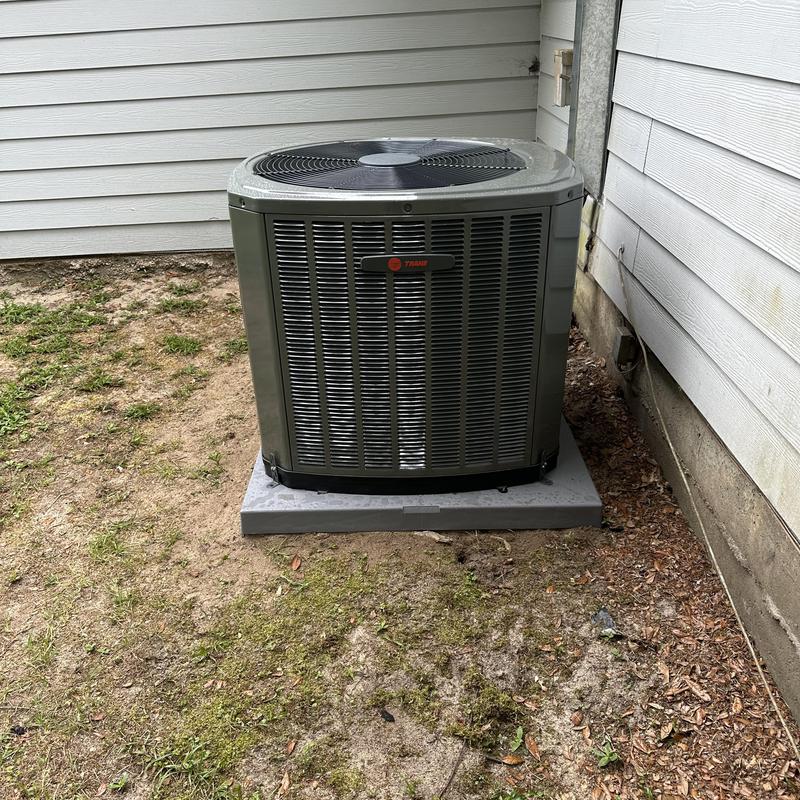 Condenser unit installed on new concrete pad outside home Condenser unit installed on new concrete pad outside home