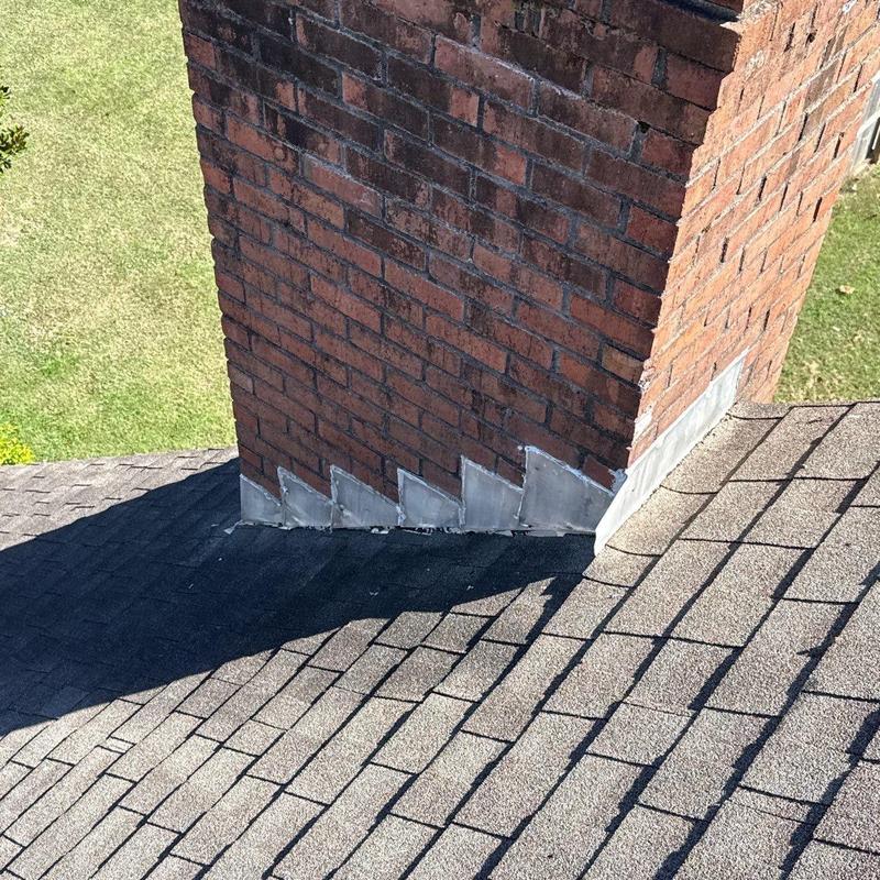 Chimney flashing on asphalt shingle roof inspection
