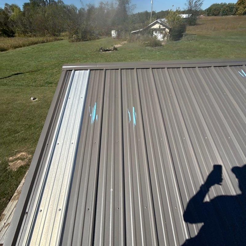 Metal roof panels with hail damage marks