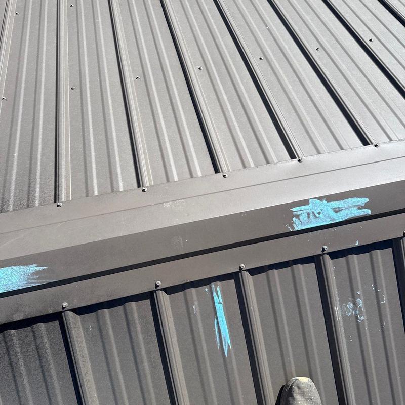Metal roofing panels with hail damage markings