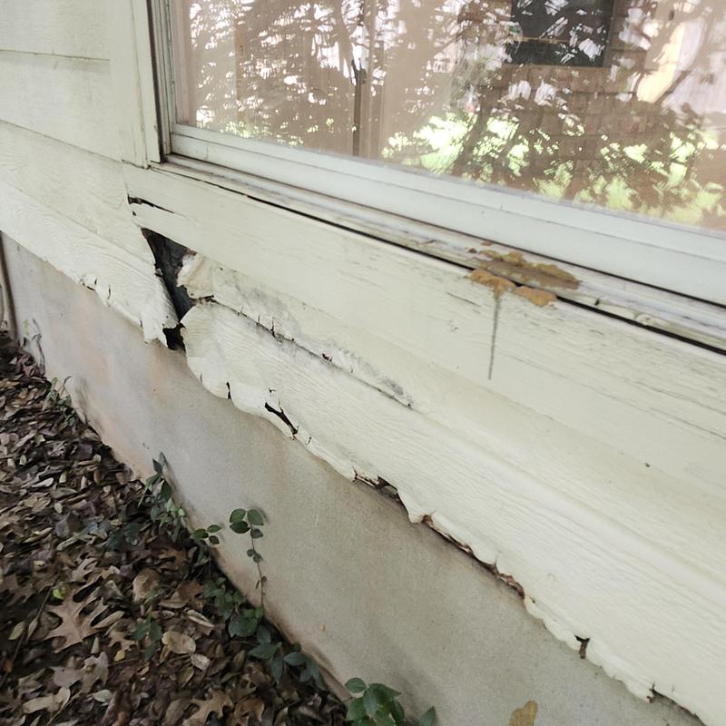 Damaged siding and fascia under window exterior
