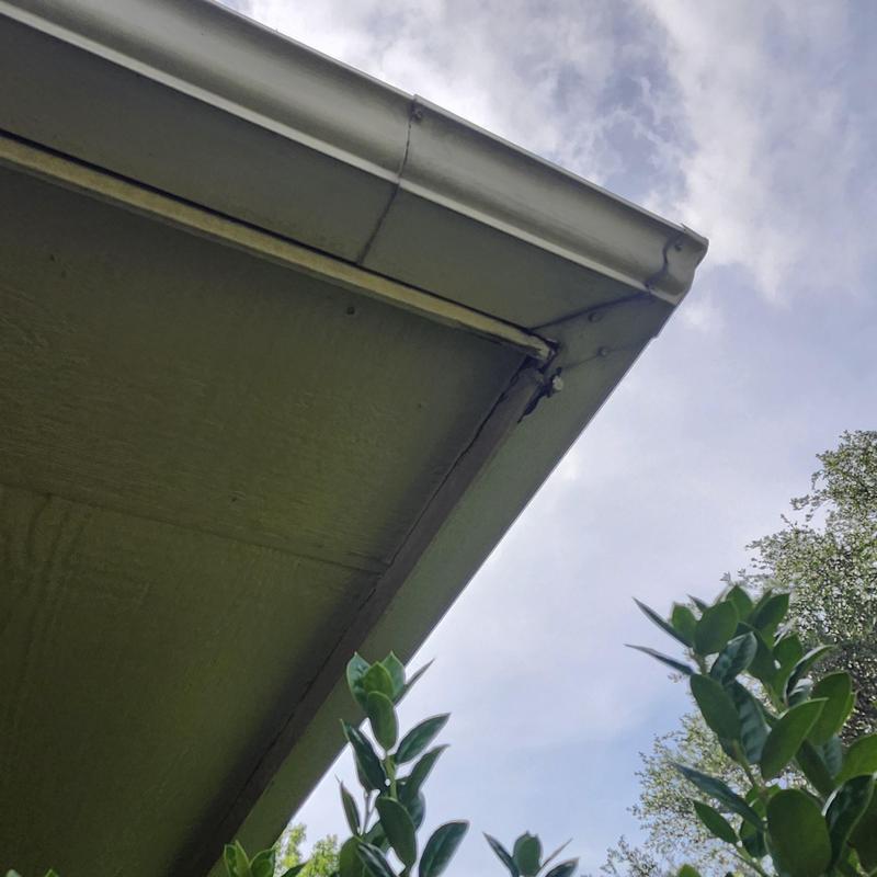 Chimney and fascia with visible damage on roof edge
