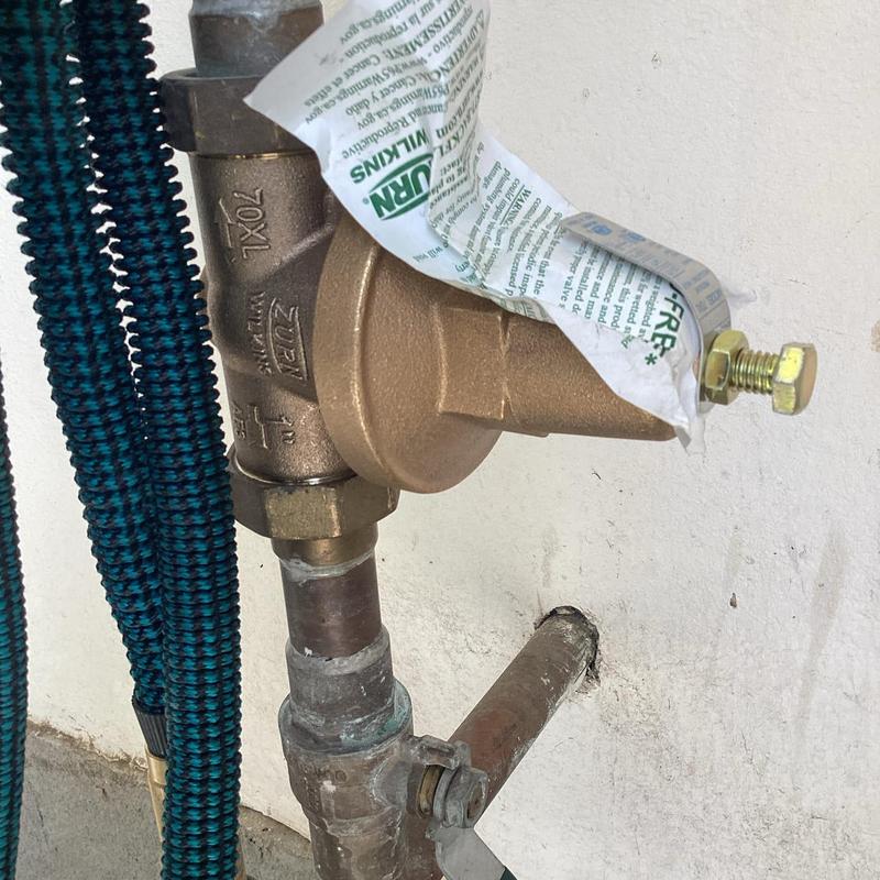 Pressure regulator valve installation on outdoor pipe