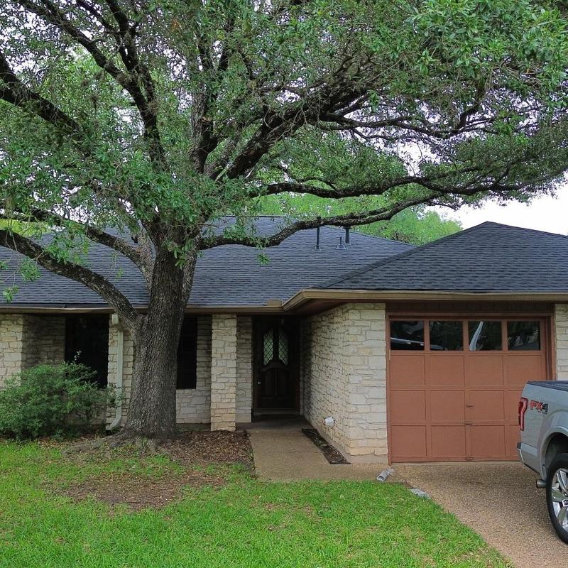 GAF charcoal shingle roof on stone home exterior
