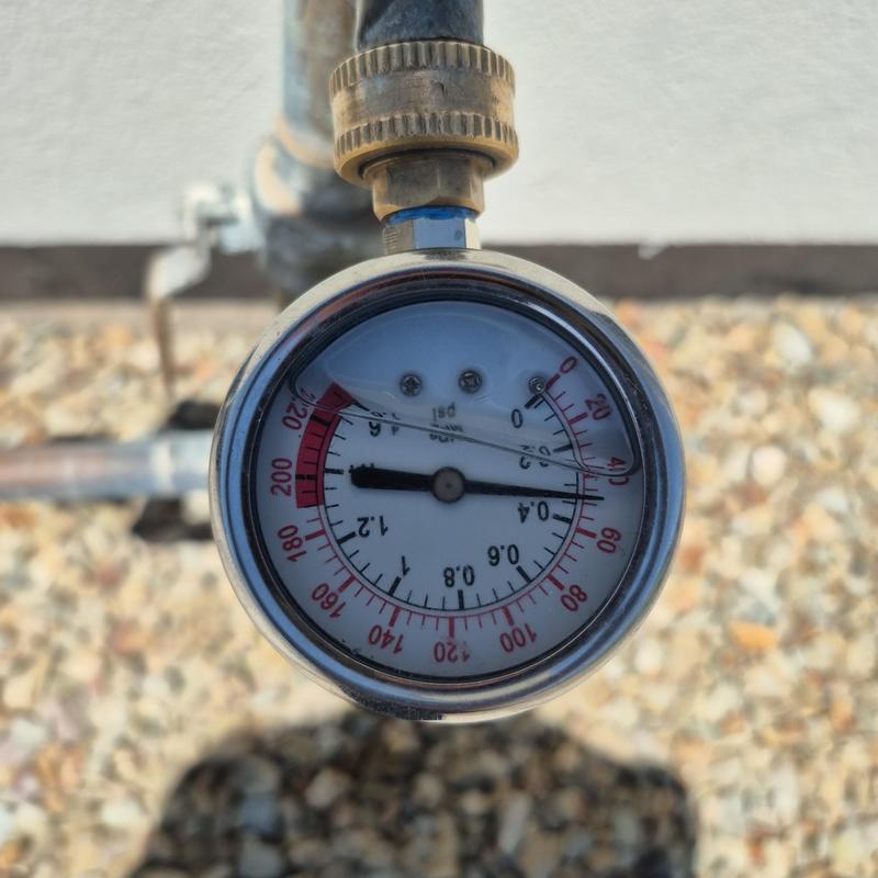 Water pressure gauge on outdoor pipe close-up Water pressure gauge on outdoor pipe close-up