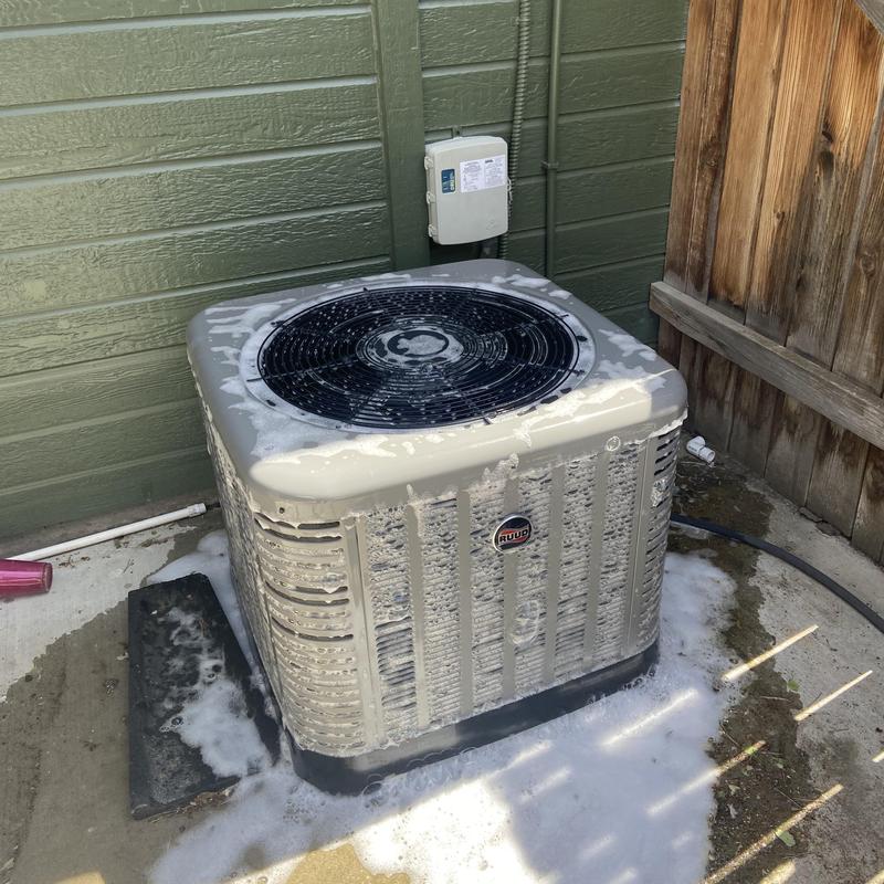 Ruud HVAC unit cleaning with foam outside house