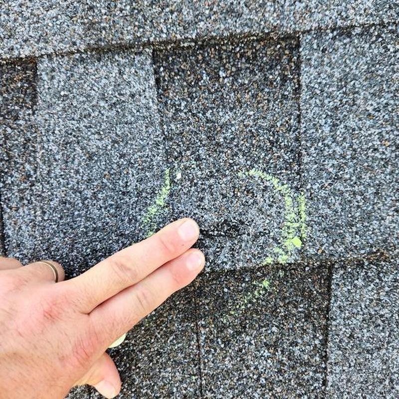 Roof shingles with chalk marking during inspection