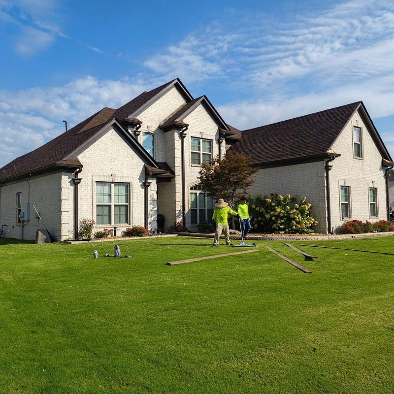 Owens Corning Oakridge asphalt roof on white brick home Owens Corning Oakridge asphalt roof on white brick home