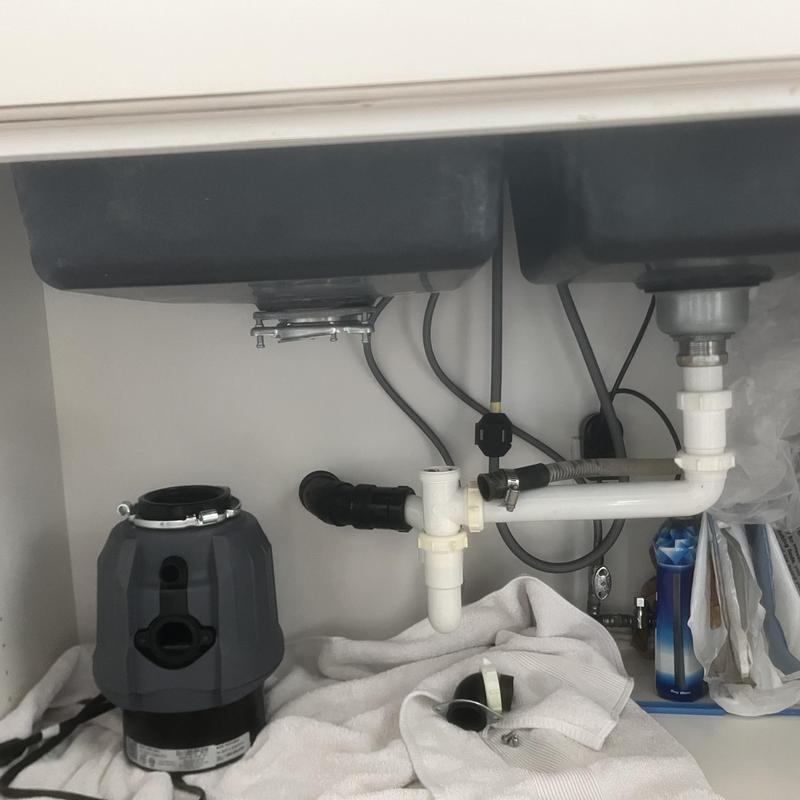 Garbage disposal unit and sink drain plumbing under cabinet