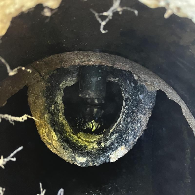 Concrete inlet baffle inside septic tank with pipe connection