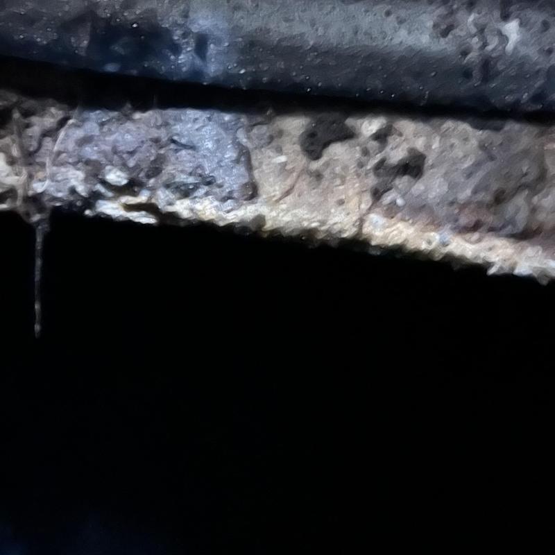 Concrete inlet baffle inside septic tank, corroded detail