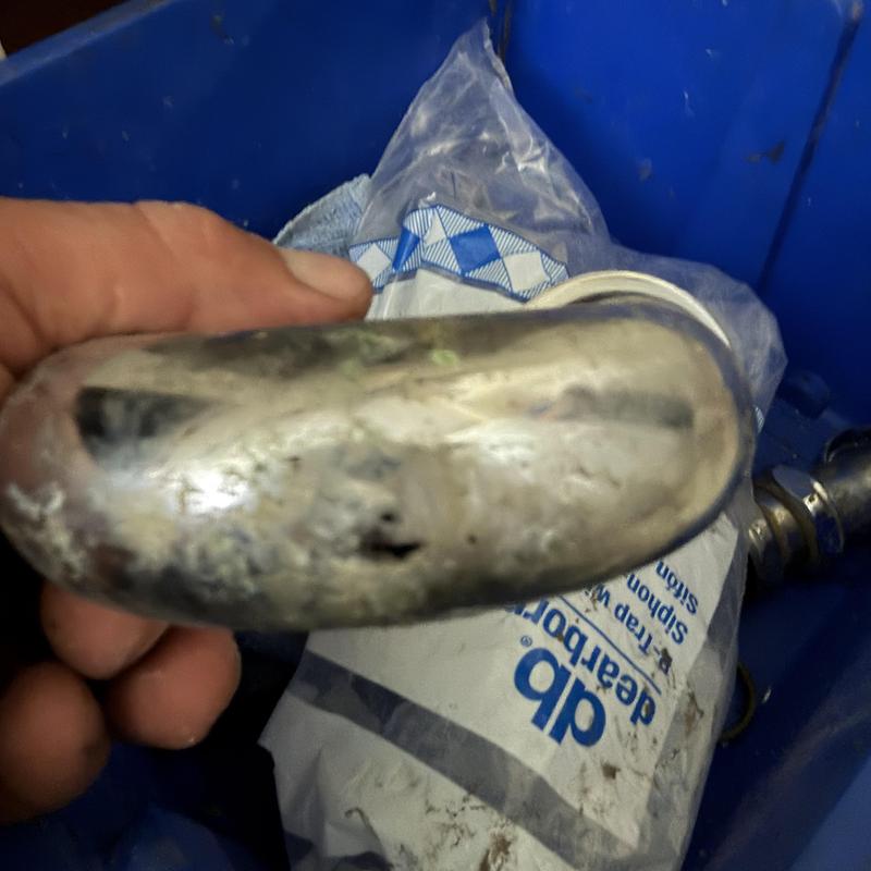 Sink drain pipe with corrosion and hole damage