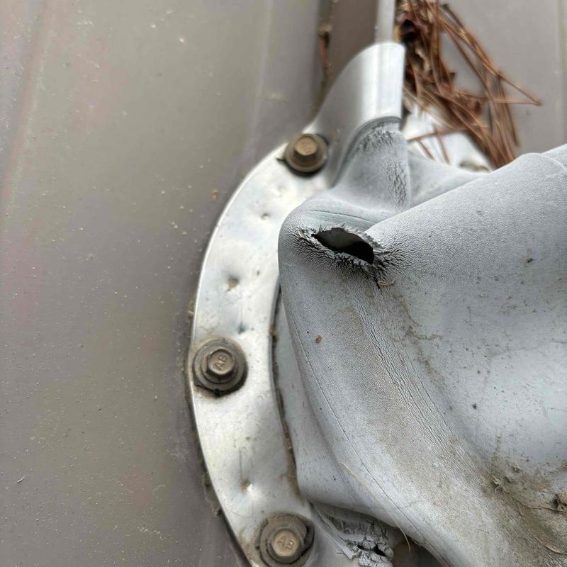 Rubber attic vent boot with large tear and damage