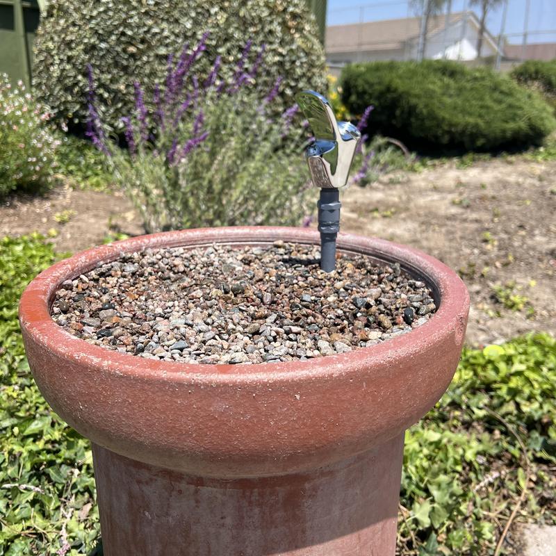 Water fountain faucet installation in outdoor planter Water fountain faucet installation in outdoor planter