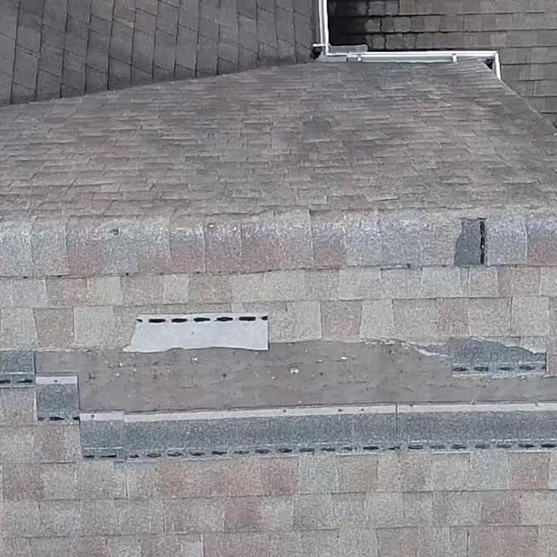 Roof shingles with damaged and missing pieces during inspection