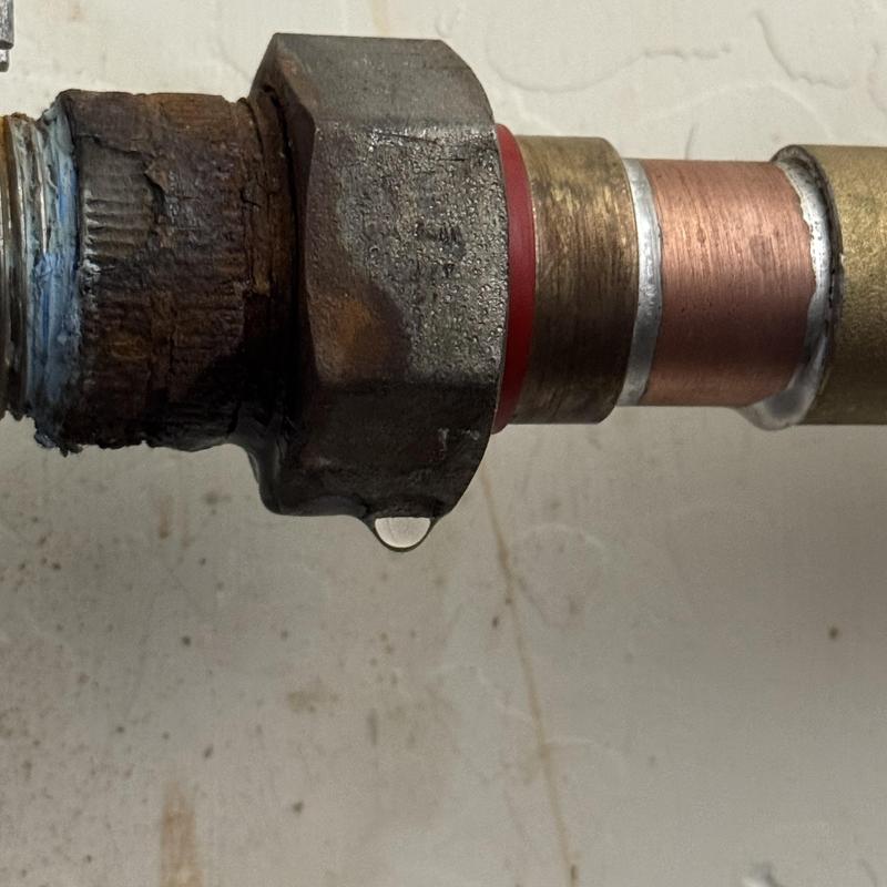 Copper pipe with leaking joint and water drop Copper pipe with leaking joint and water drop