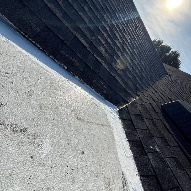 Shingle roof and porch flashing junction with sealant
