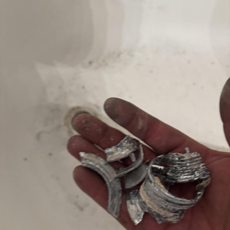 Tub drain stopper chrome pieces in hand close-up Tub drain stopper chrome pieces in hand close-up