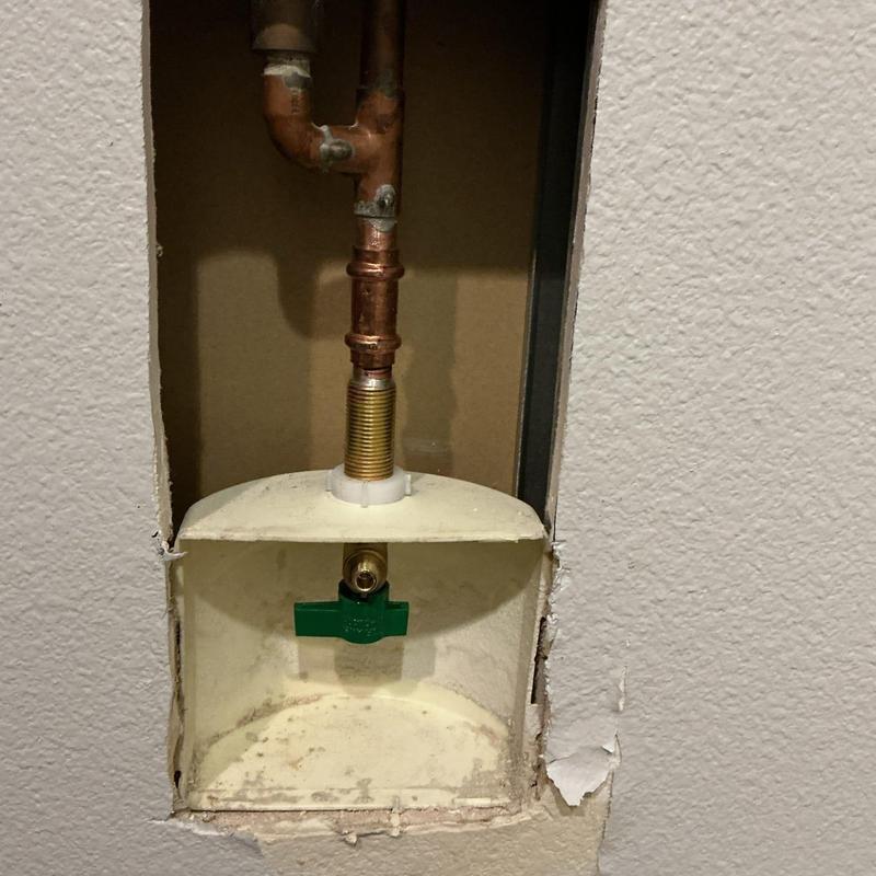 Ice maker shut-off valve and copper piping in drywall opening