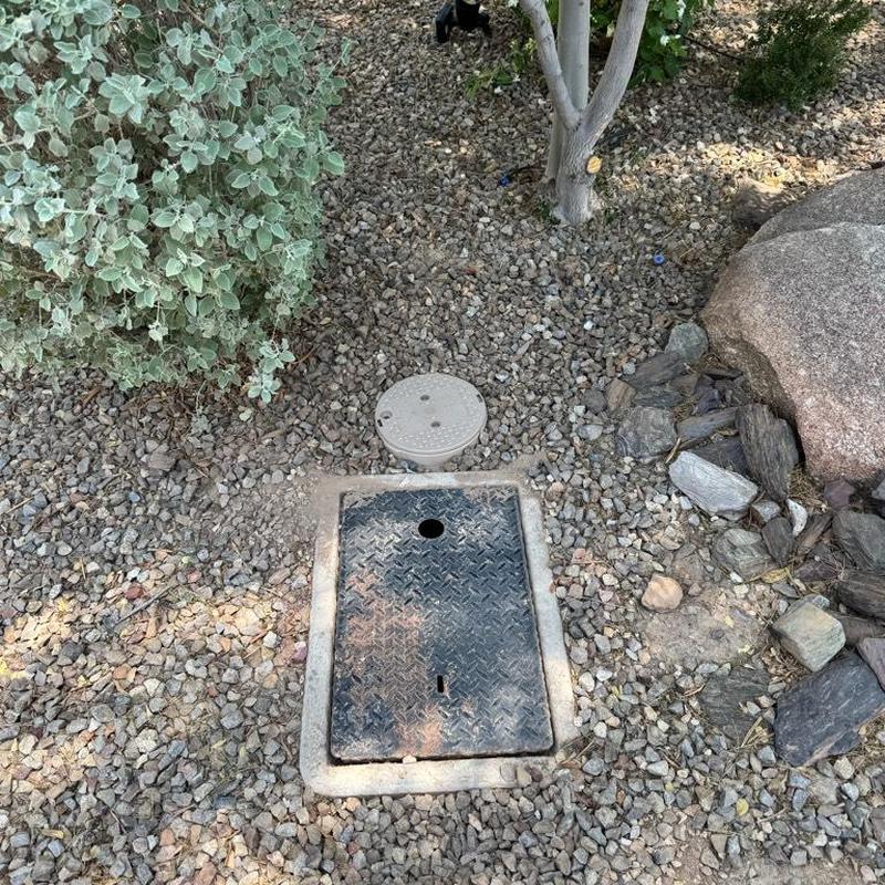 Water main and irrigation boxes with landscape rock