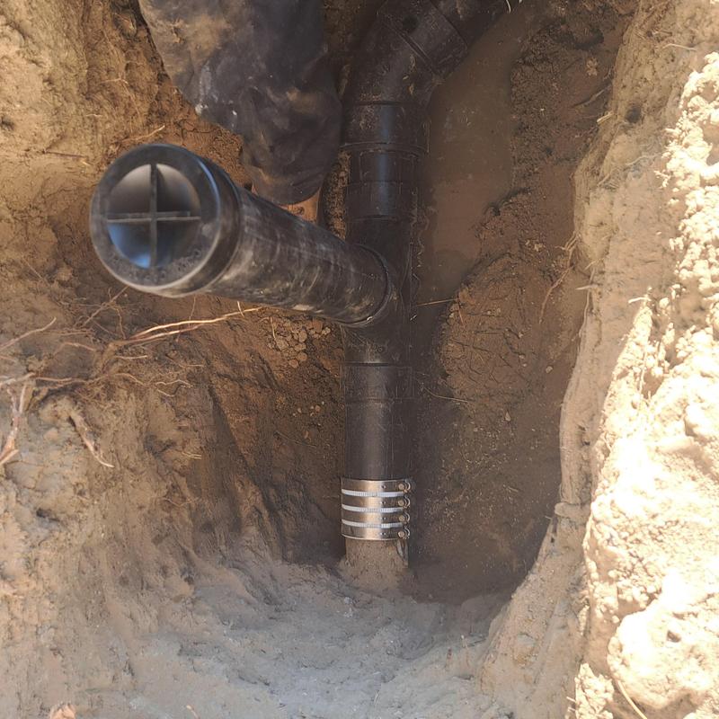 Cast iron pipe connection with hose clamps underground