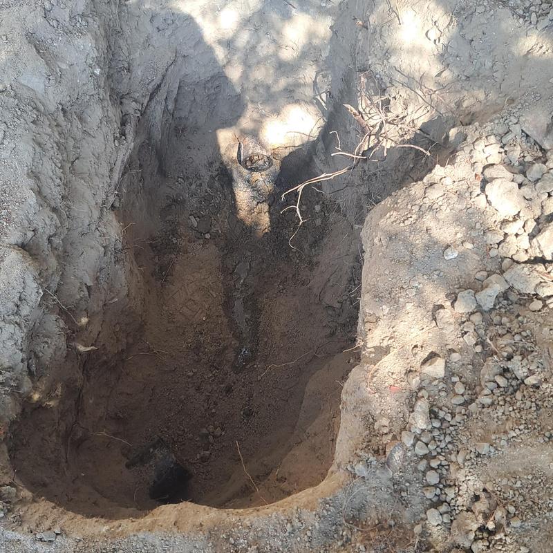 Cast iron pipe under slab excavation and cleaning
