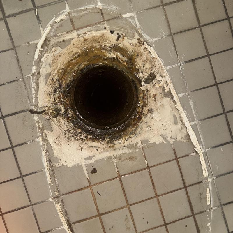 Toilet flange and floor tile with old wax ring residue Toilet flange and floor tile with old wax ring residue