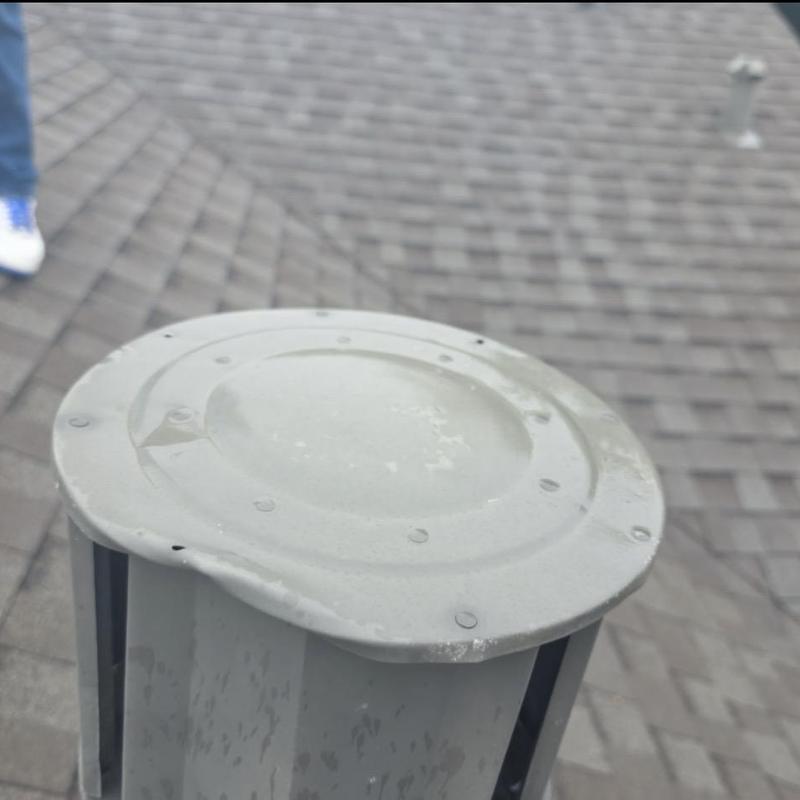 Roof vent with hail damage on asphalt shingles Roof vent with hail damage on asphalt shingles