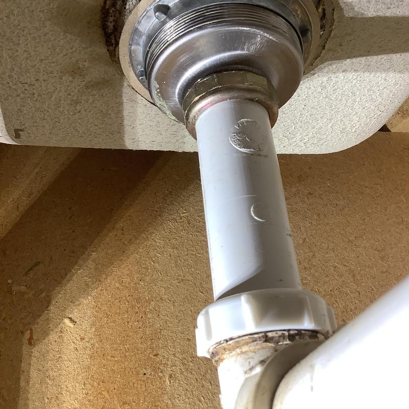Kitchen sink basket strainer with PVC drain pipe under sink Kitchen sink basket strainer with PVC drain pipe under sink