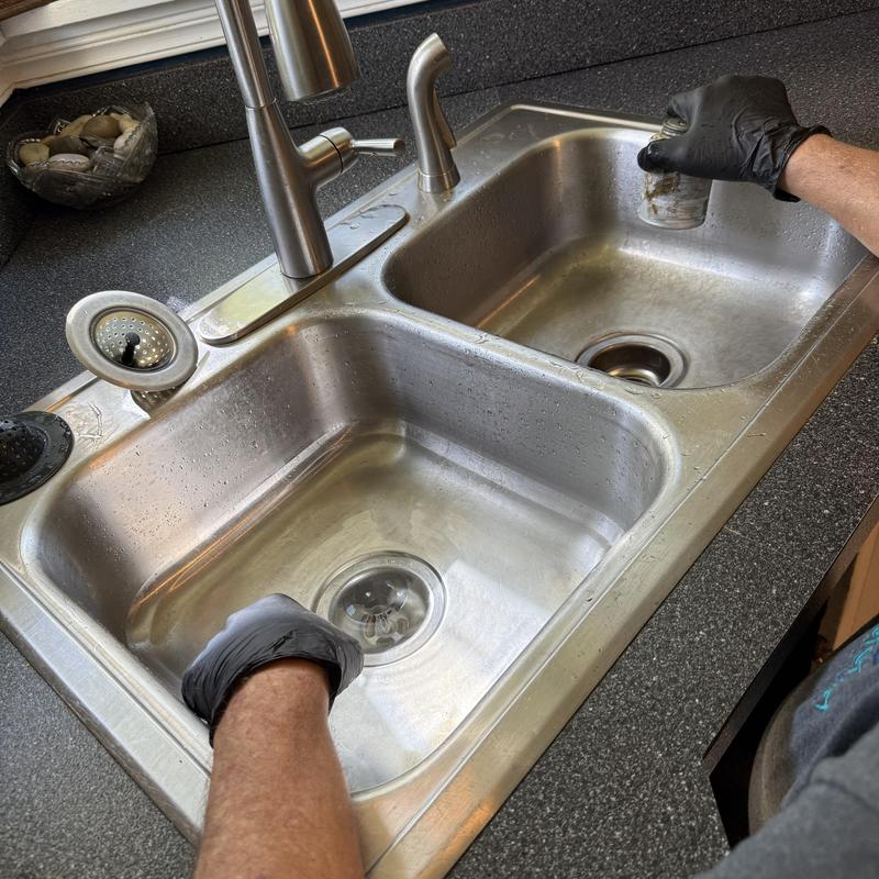 Kitchen sink drain cleaning by plumber with gloves Kitchen sink drain cleaning by plumber with gloves