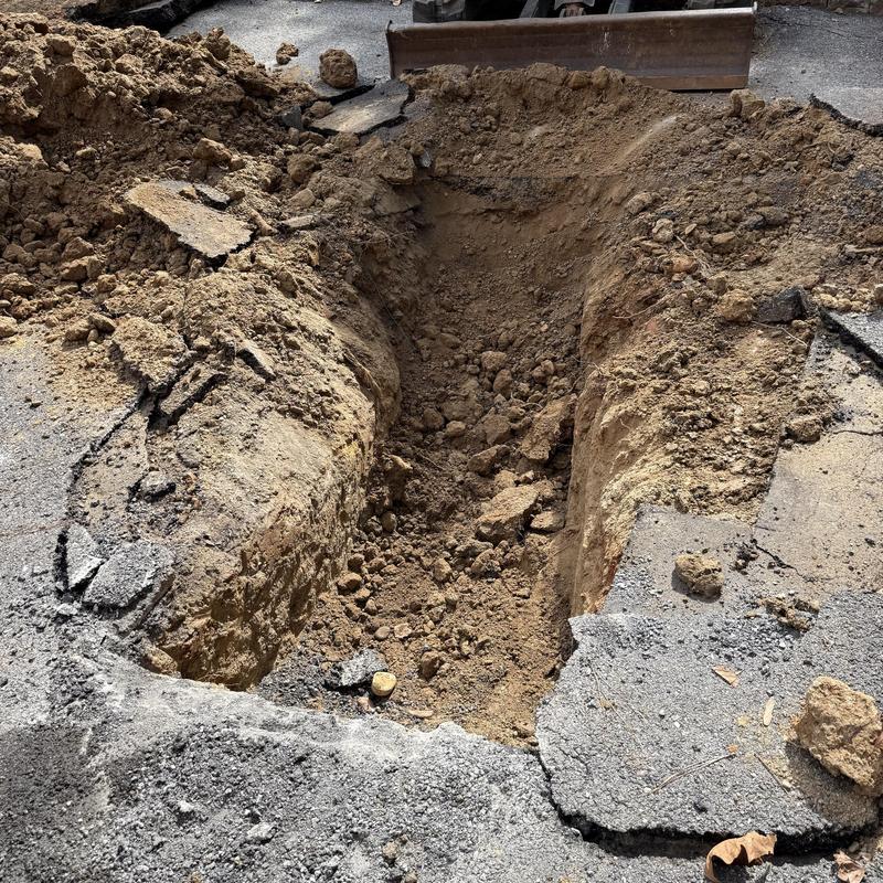 Sewer line excavation in asphalt driveway Sewer line excavation in asphalt driveway