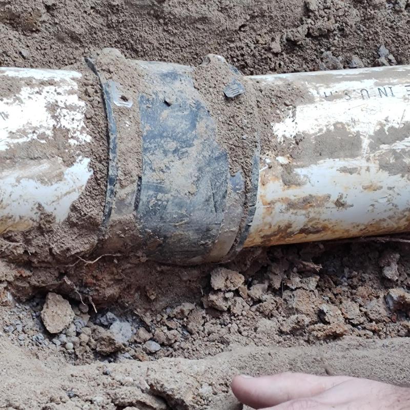 Sewer line pipe joint with clamp in soil excavation Sewer line pipe joint with clamp in soil excavation