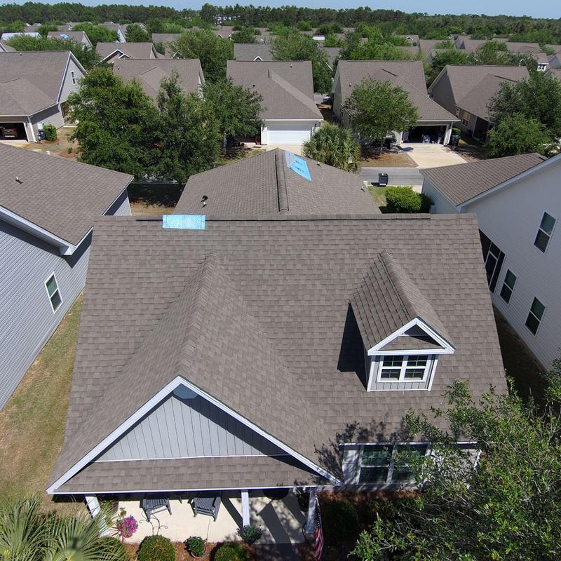 Asphalt shingle roof with blue synthetic underlayment patches Asphalt shingle roof with blue synthetic underlayment patches