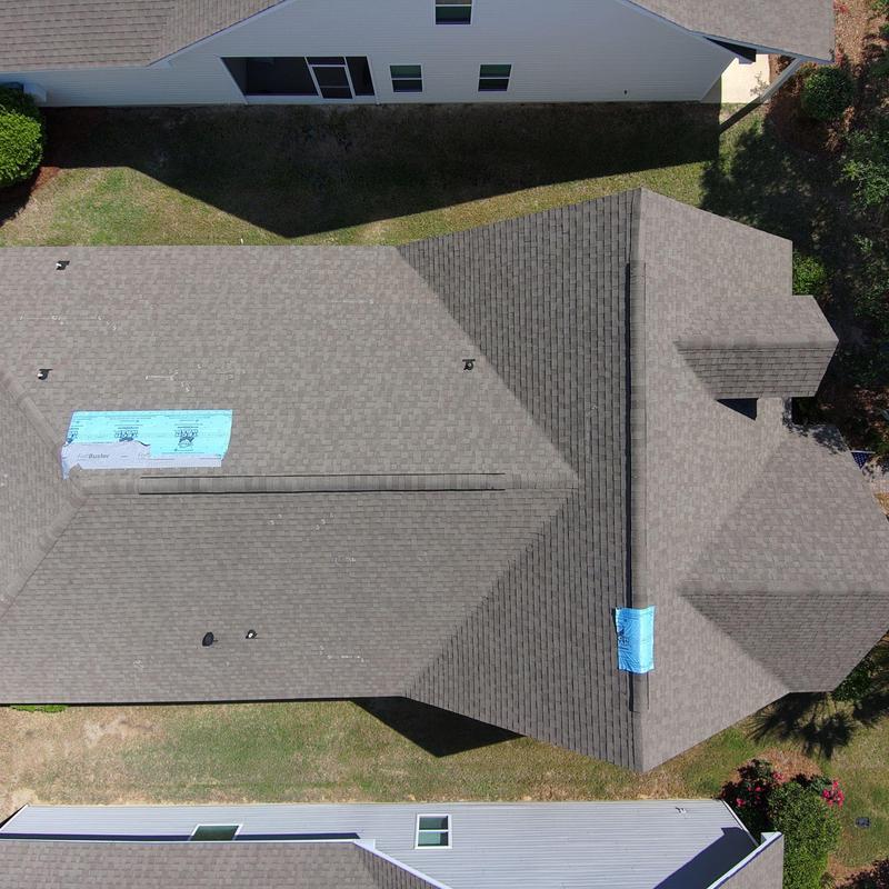 Shingle roof with blue synthetic underlayment patches Shingle roof with blue synthetic underlayment patches