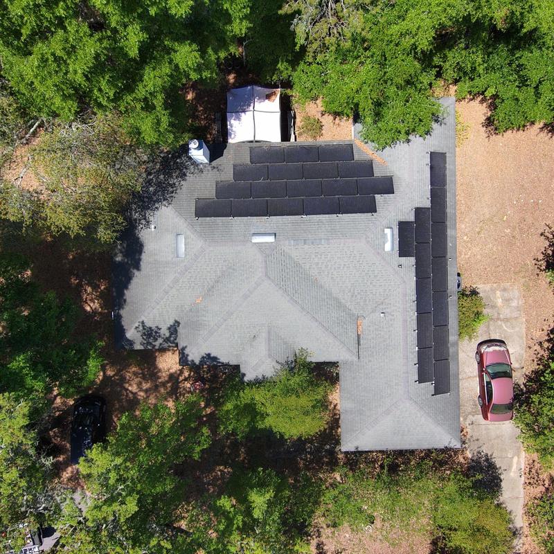 Solar panel array on residential roof aerial view Solar panel array on residential roof aerial view