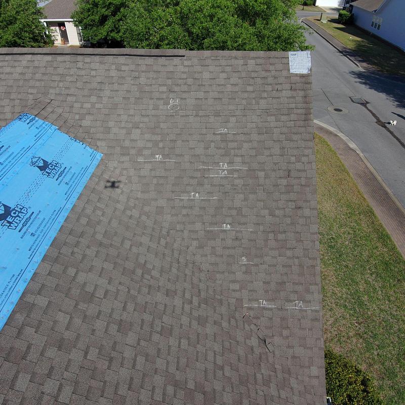 Asphalt shingles with white chalk markings on roof Asphalt shingles with white chalk markings on roof