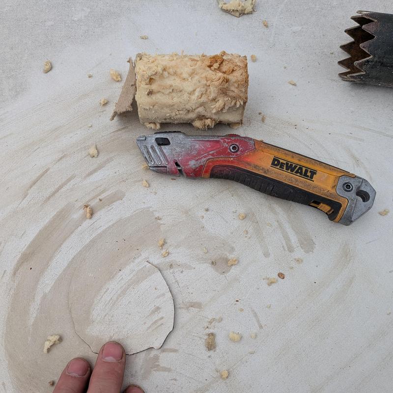 TPO roofing membrane with utility knife and insulation debris TPO roofing membrane with utility knife and insulation debris