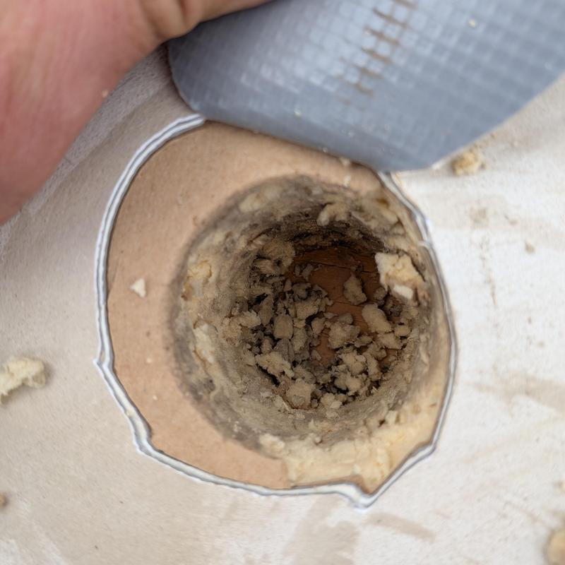 TPO roof insulation damage hole close-up with debris TPO roof insulation damage hole close-up with debris