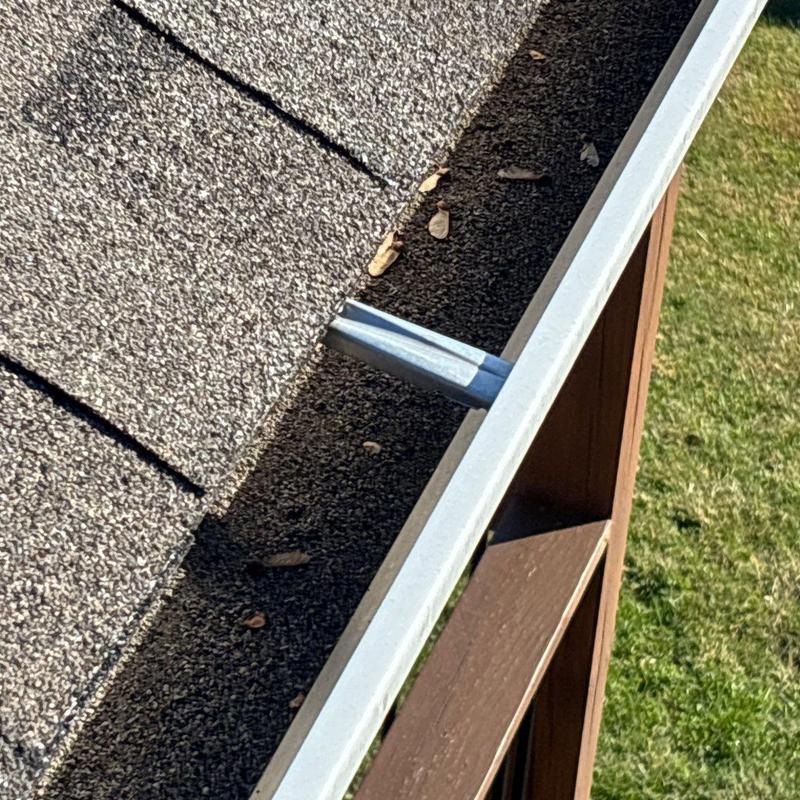 Asphalt shingle roof and metal gutter inspection with debris