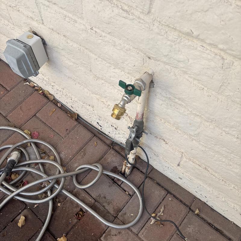 Outdoor hose bib with attached water hoses Outdoor hose bib with attached water hoses