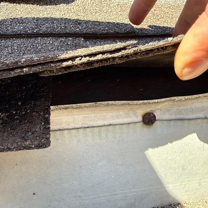 Damaged roof shingles and underlayment inspection detail