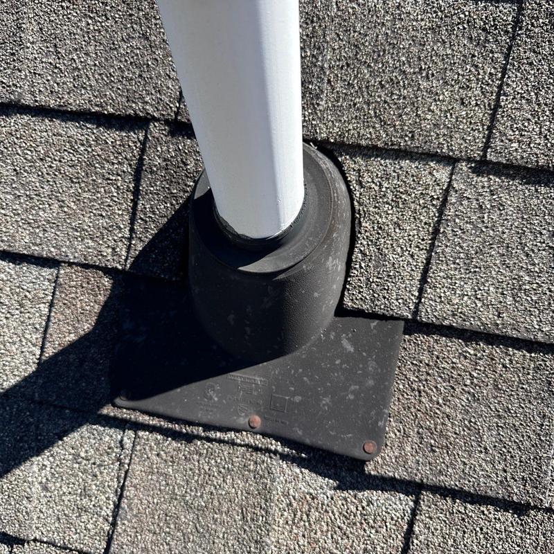 Roof pipe flashing on shingle roof showing wear