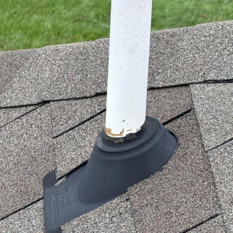 Roof vent pipe flashing with damaged shingles and sealant