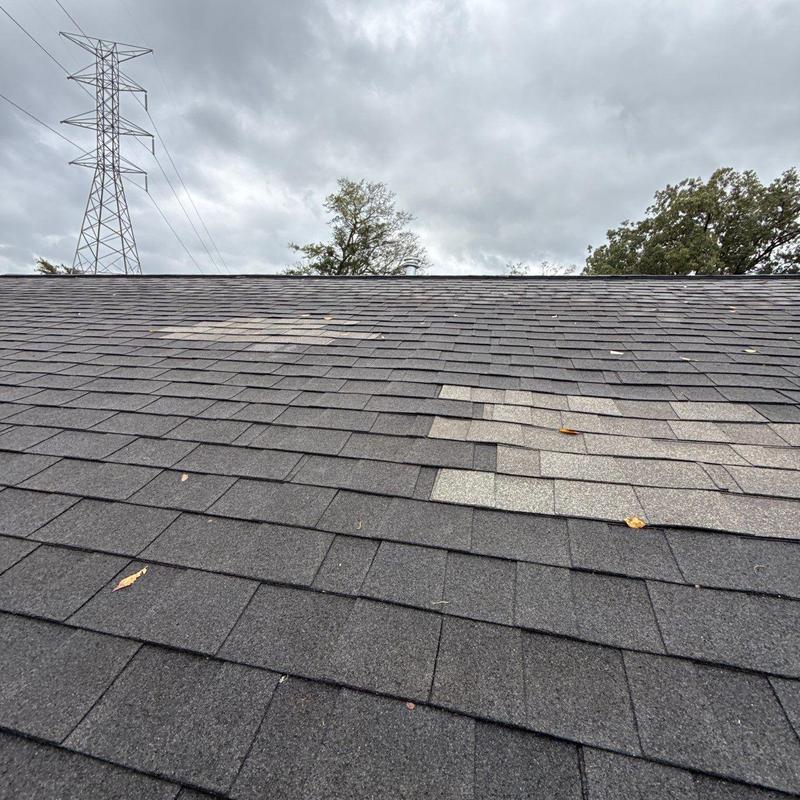 Asphalt shingle roof with hail damage patches